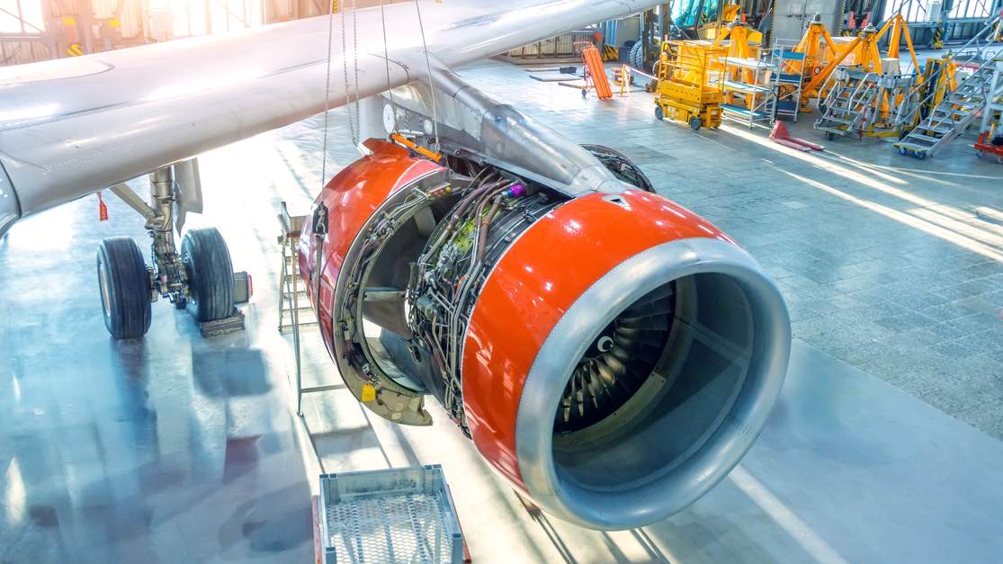 Open engine cowling of an airplane during maintenance in a hangar