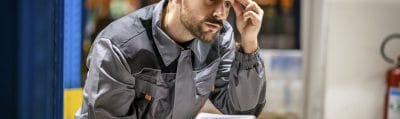Warehouse worker pausing over a problem with an order