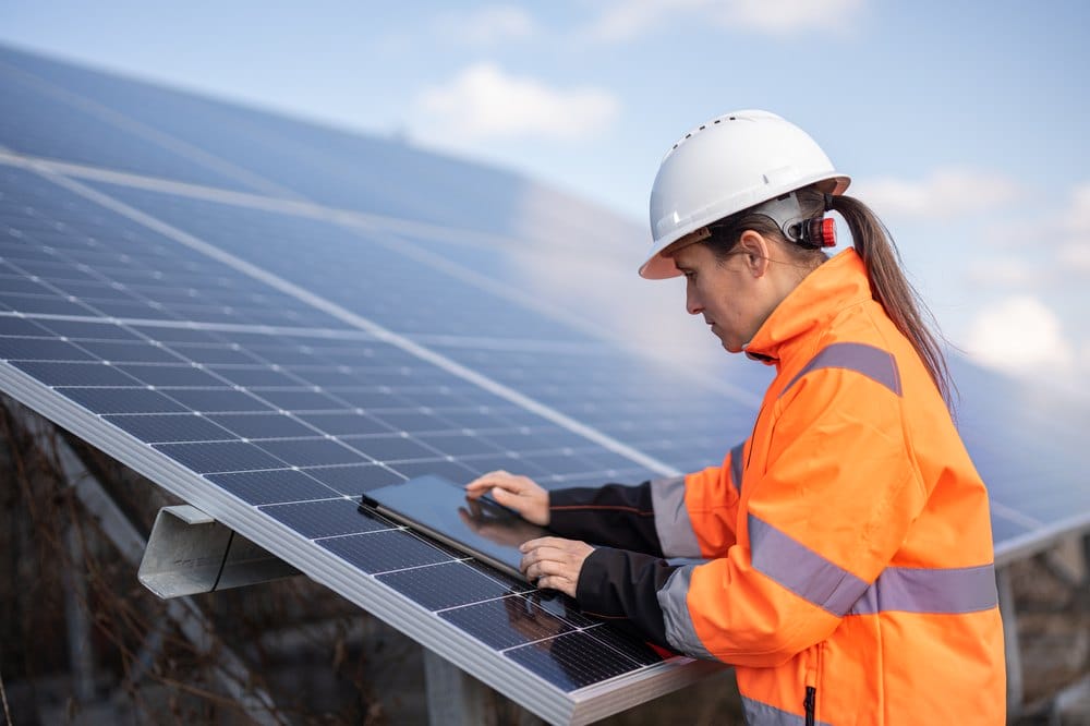 Female engineer with a tablet at a solar power plant