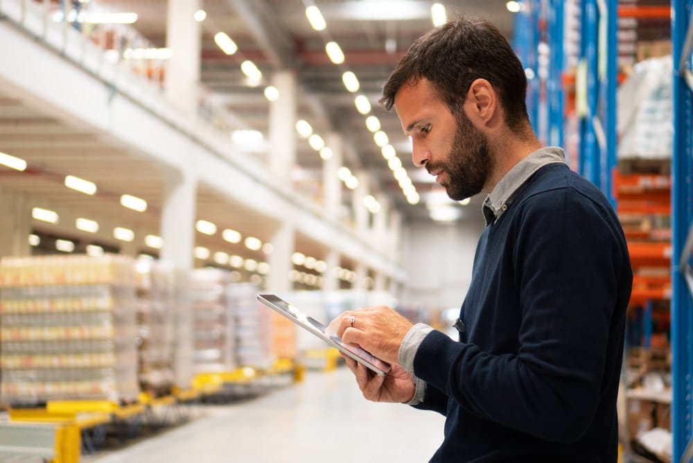 Manager holding a digital tablet in a warehouse