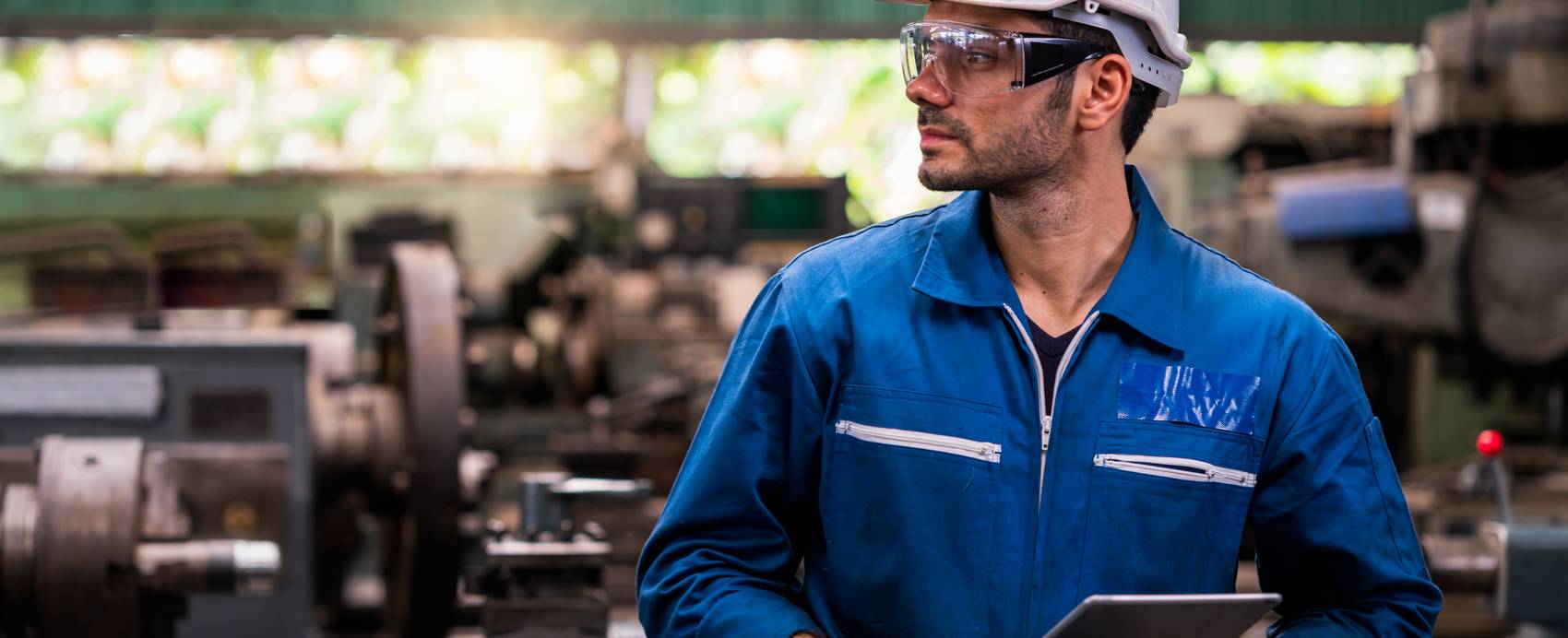 Engineers maintaining machinery in an industrial plant