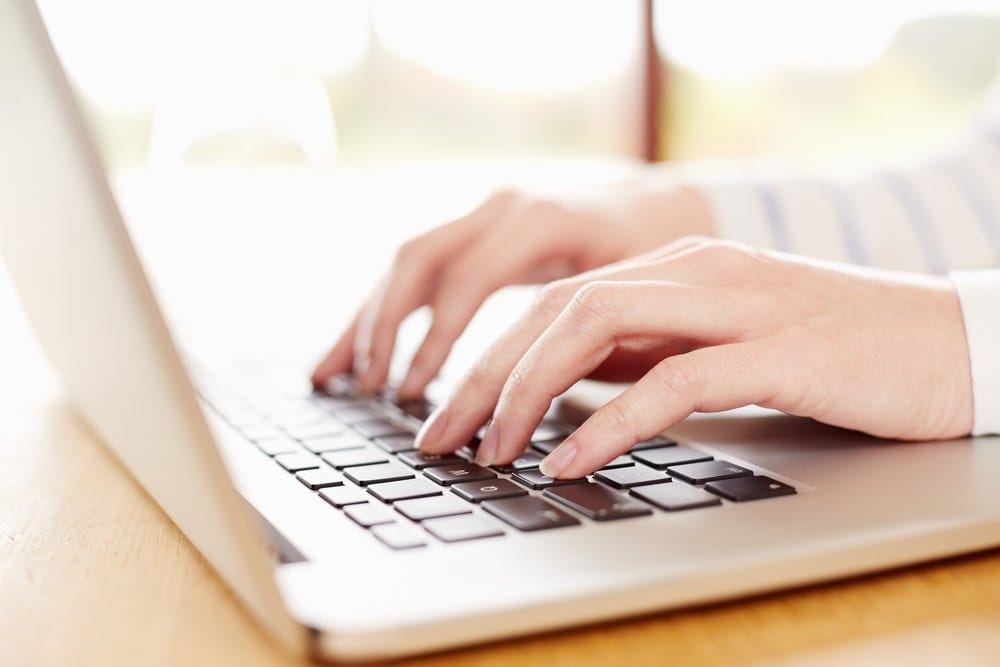 Sourcing specialist searching supplier networks on a laptop