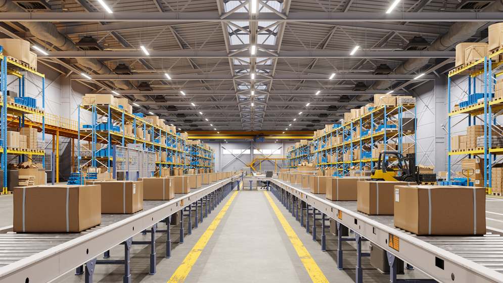 Cardboard boxes on conveyor belts running through a distribution warehouse