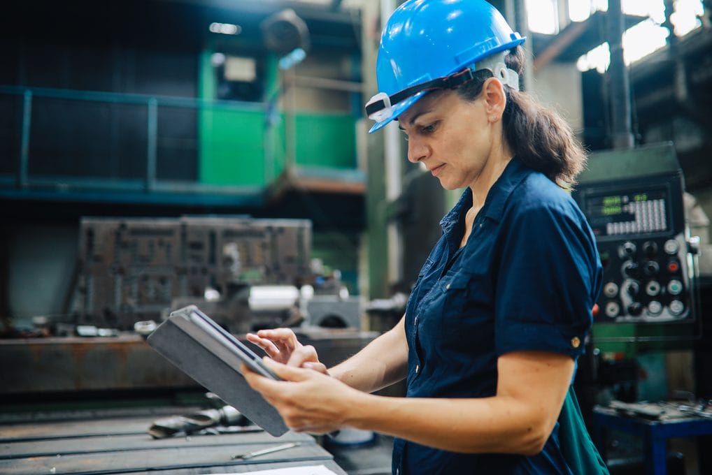 Quality control inspector examining a component in a manufacturing facility